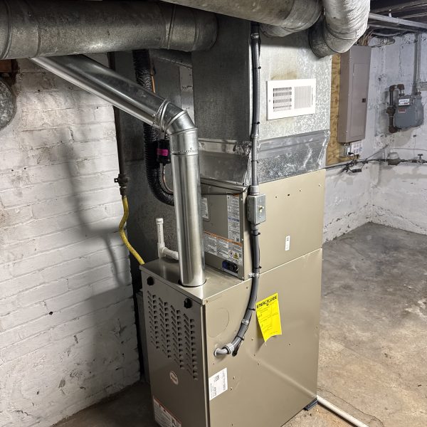 New high-efficiency furnace and flue installed in the same basement by Hoov Air