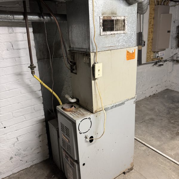 Old furnace in a basement before Hoov Air replaced it